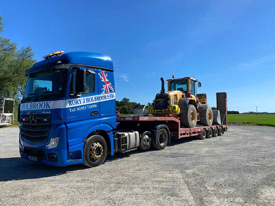 Low loader transporting small cargo for a customer
