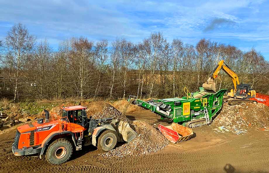 Mixed gravel being screened at recycling center