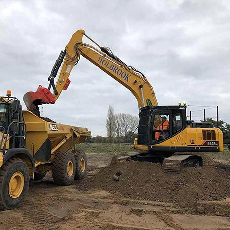 Site clearance being undertaken using grab and 8 wheeler lorries
